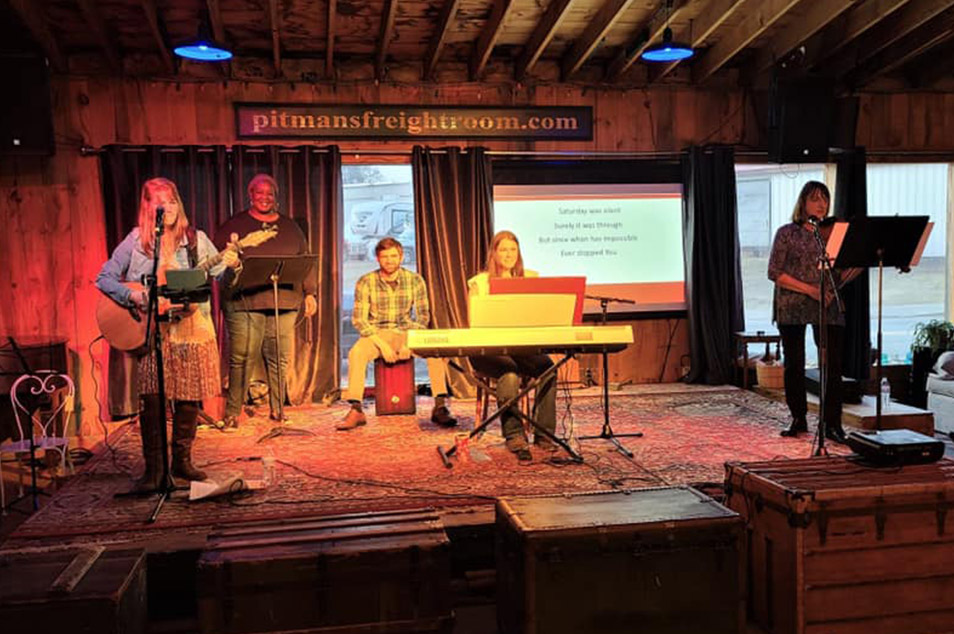 Uncaged playing worship on stage in Isaiah 61 Cafe.