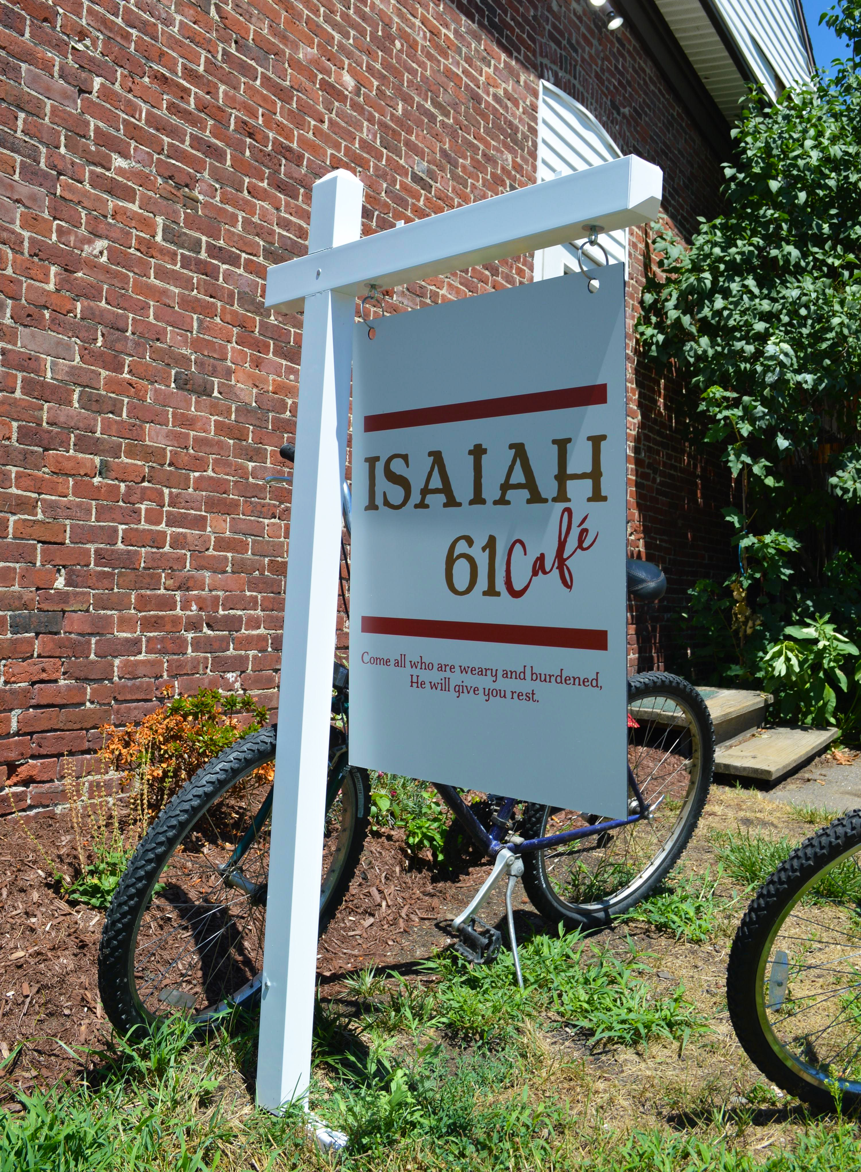 Photo of Dawn worshipping with guitar in front of statue at the park outreach.